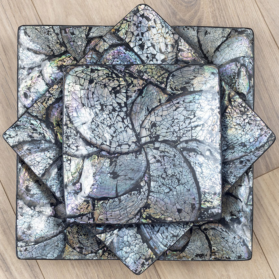 A collection of abalone shell plates stacked on top of one another