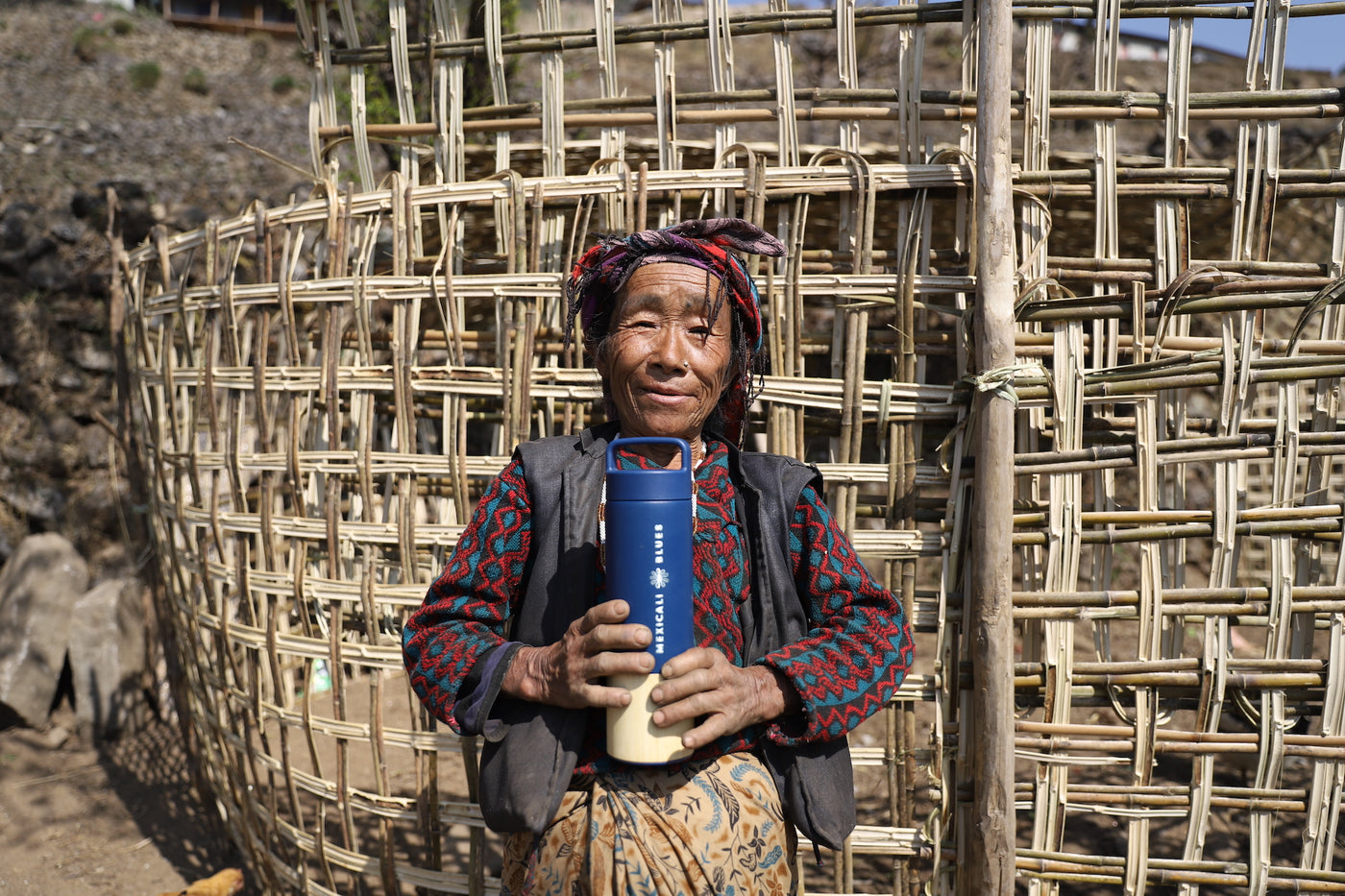 Woman holding Mexicali Blues water bottle in Nepal