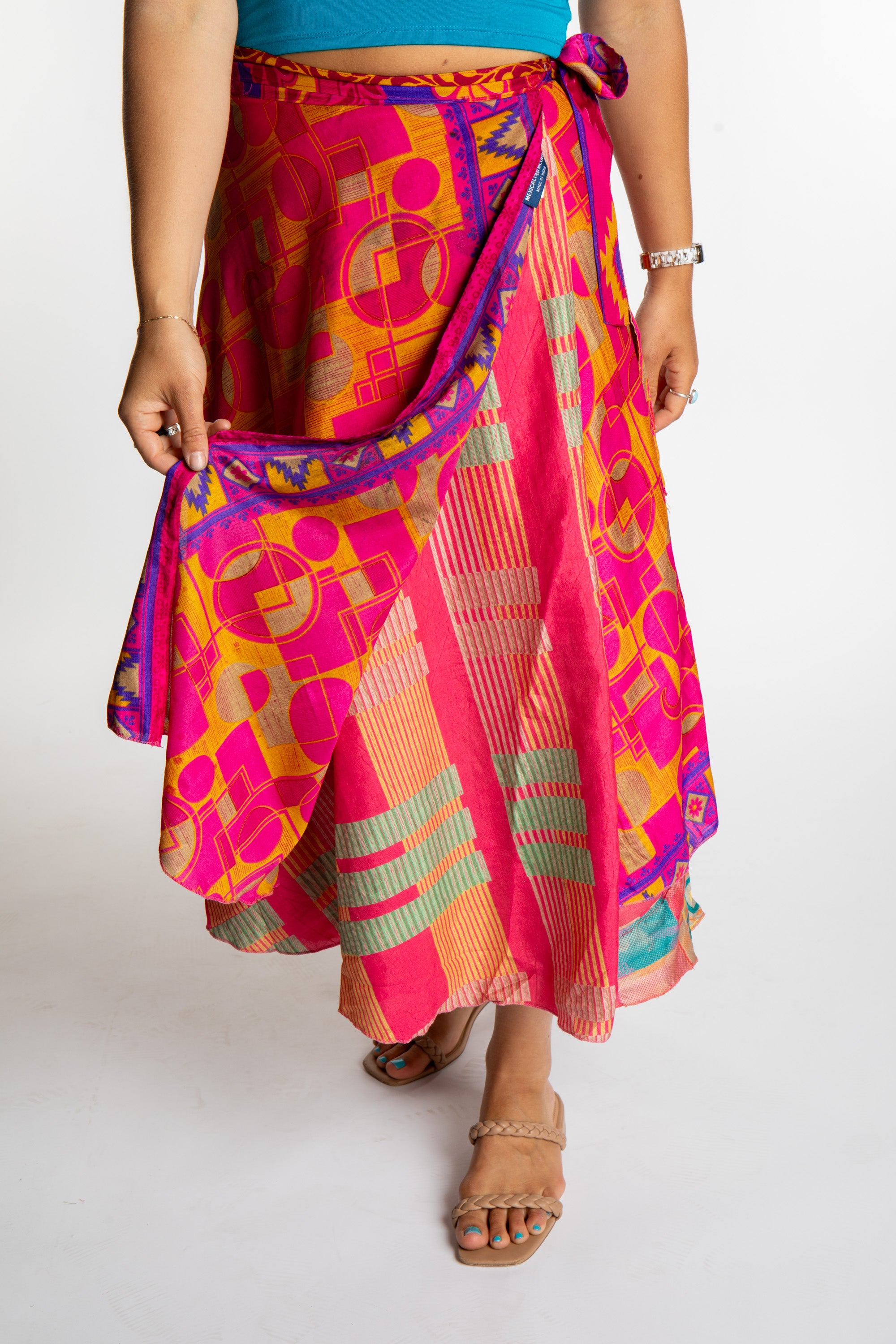 Sophie is wearing a long reversible silk wrap skirt in sugar magnolia