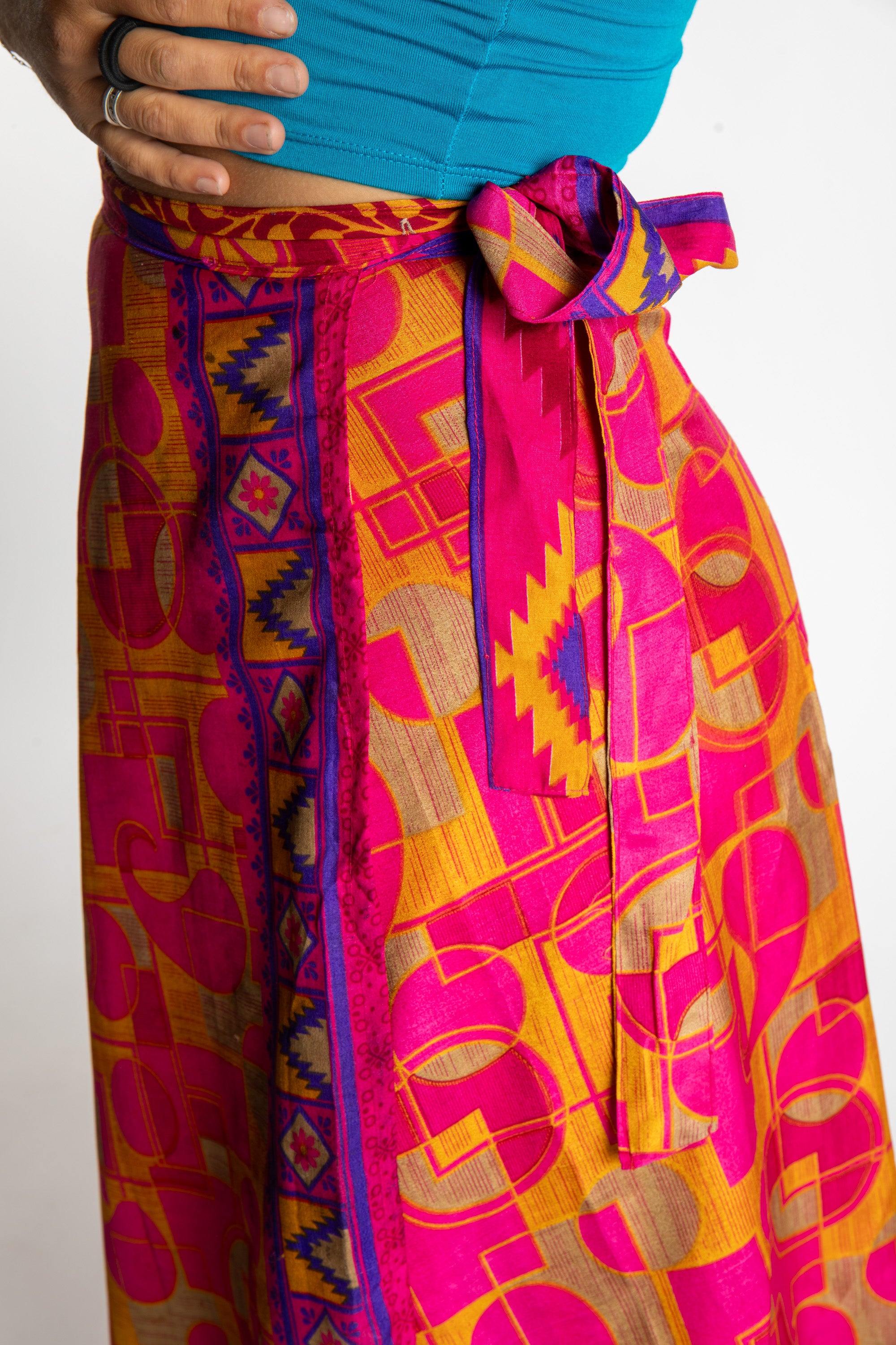 Sophie is wearing a long reversible silk wrap skirt in sugar magnolia