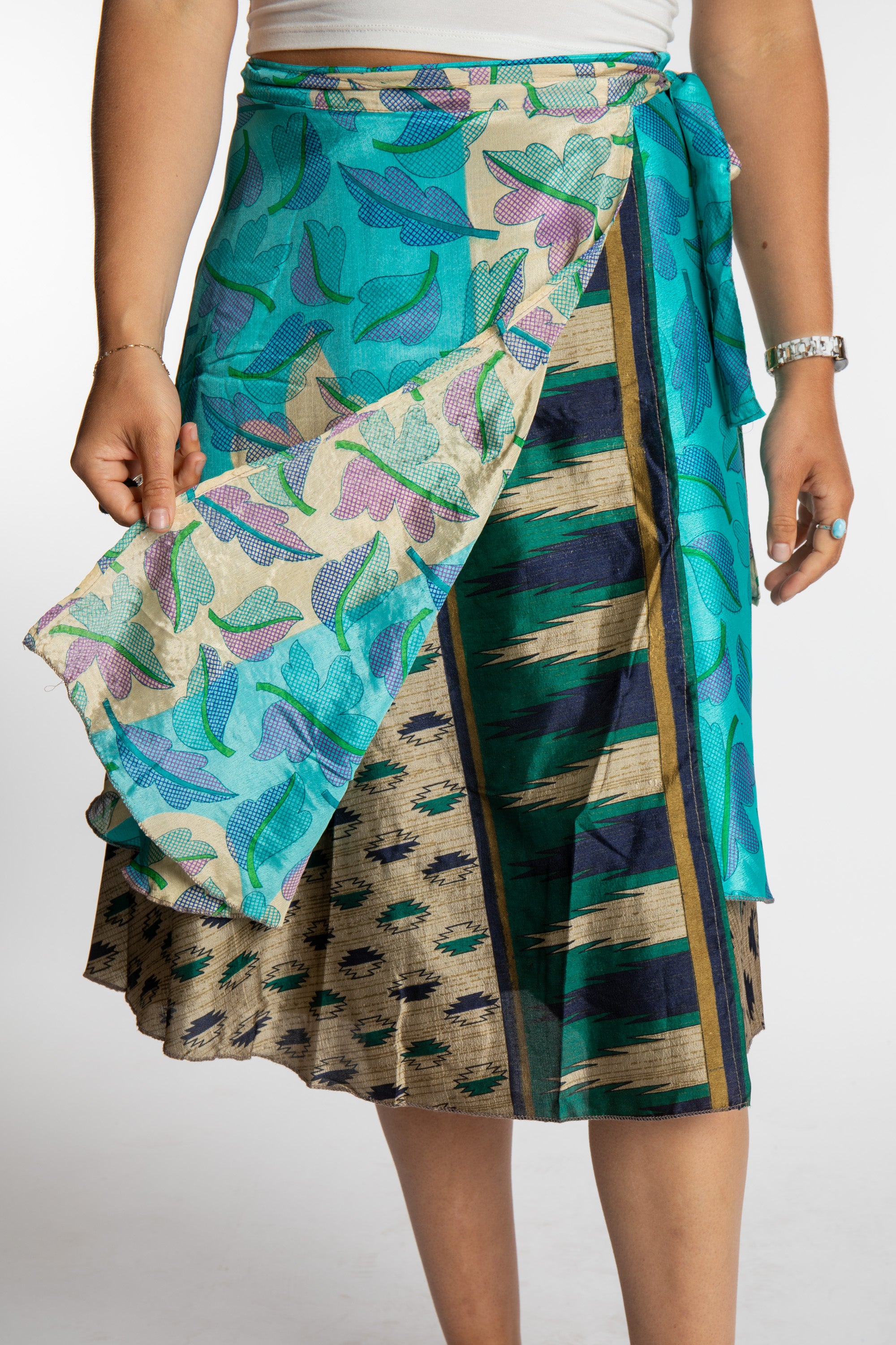 Sophie is wearing a midi reversible silk wrap skirt in morning dew