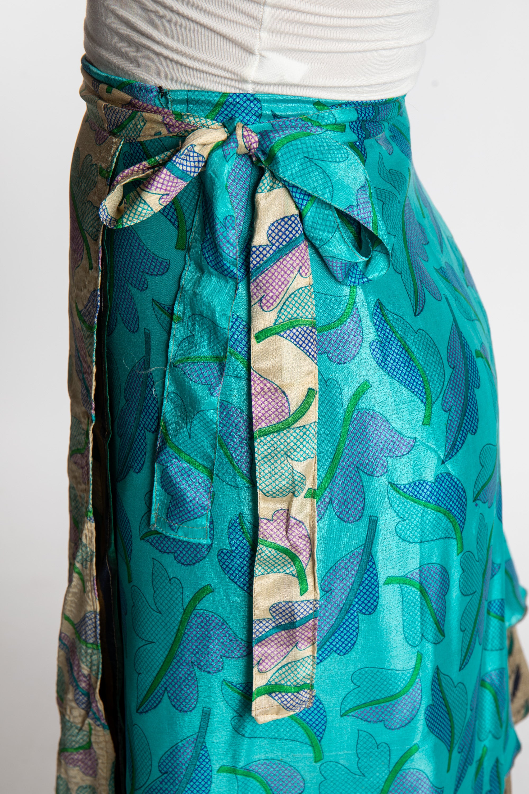 Sophie is wearing a midi reversible silk wrap skirt in morning dew
