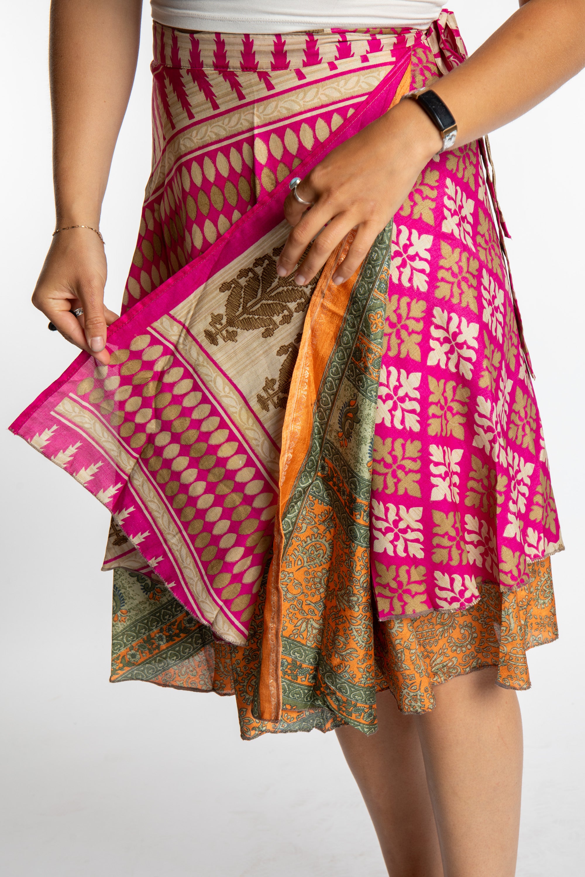 Sophie is wearing a midi reversible silk wrap skirt in sugar magnolia