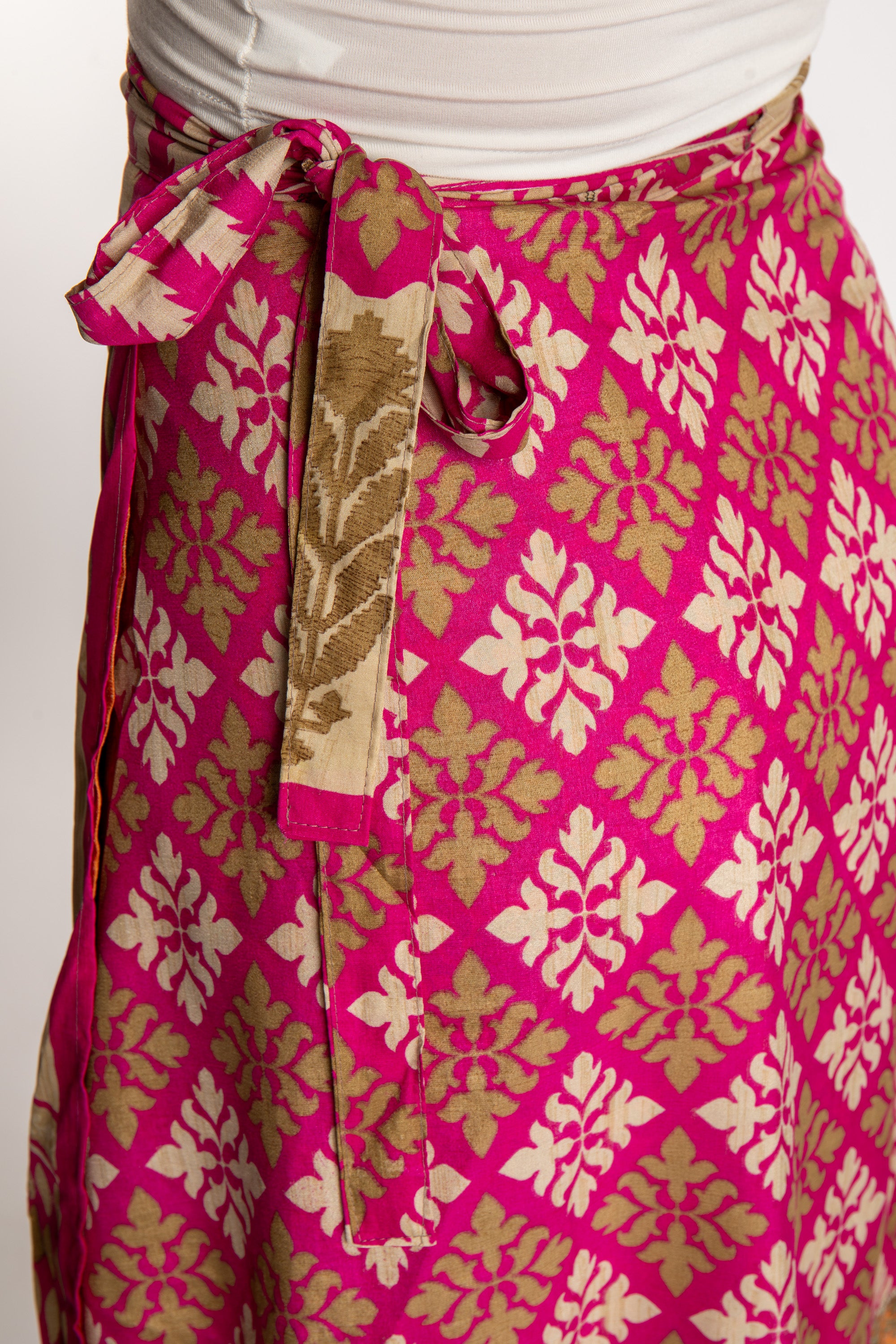 Sophie is wearing a midi reversible silk wrap skirt in sugar magnolia