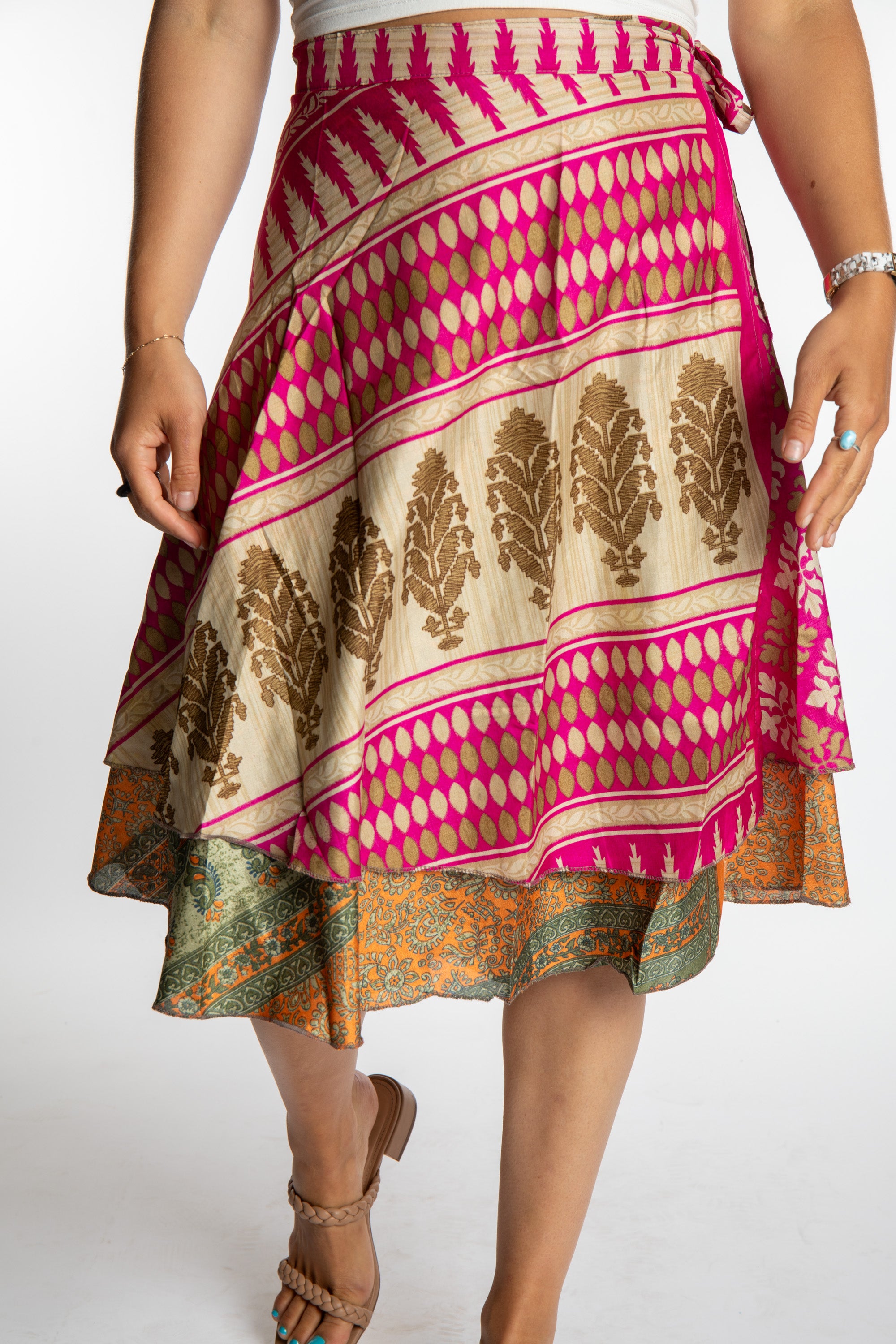 Sophie is wearing a midi reversible silk wrap skirt in sugar magnolia