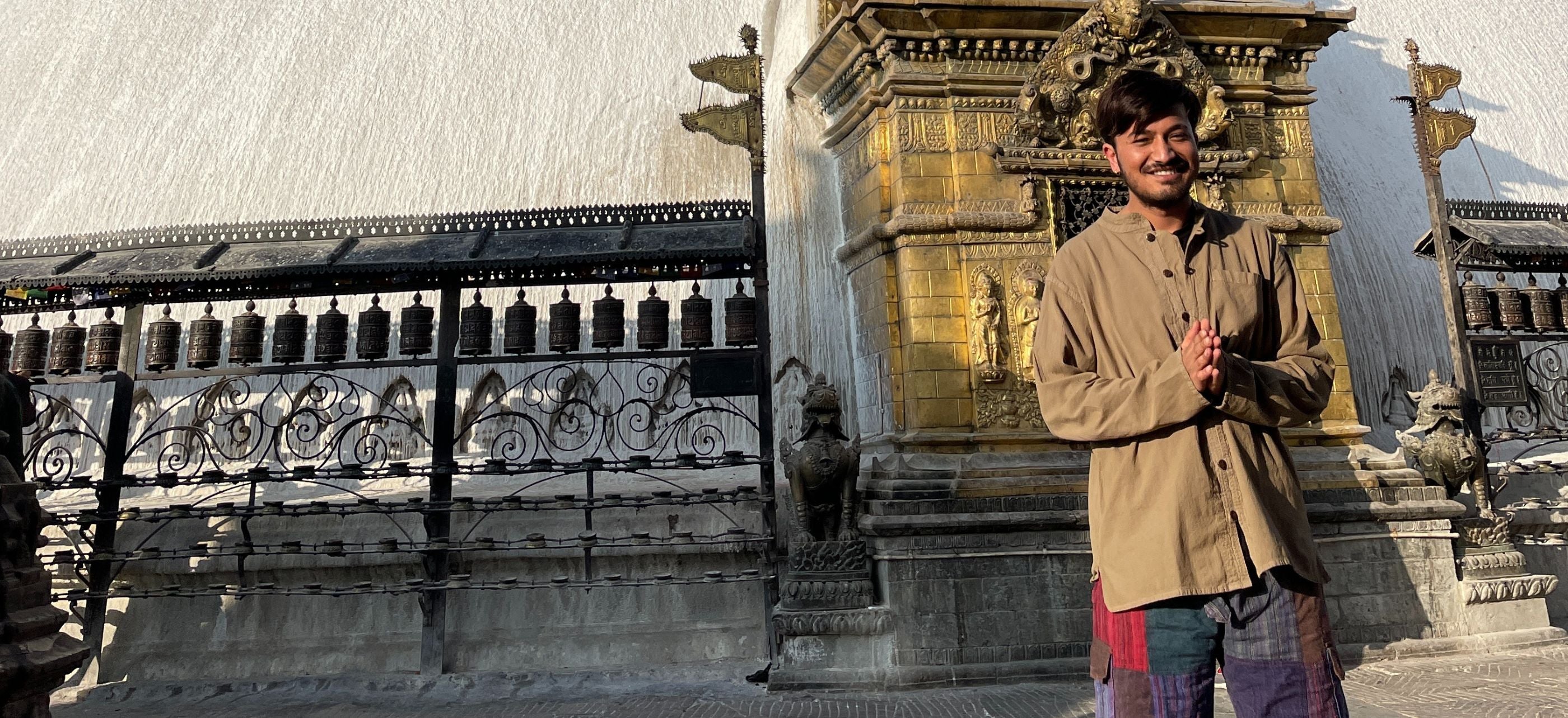 Mexicali Maker Rohit from Kathmandu saying namaste while wearing his Lung Ta Cotton Poet shirt