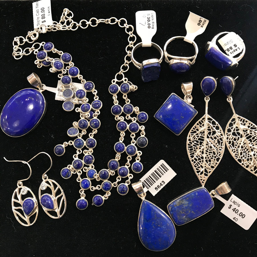 a collection of beautiful Lapis Lazuli jewelry on a black background