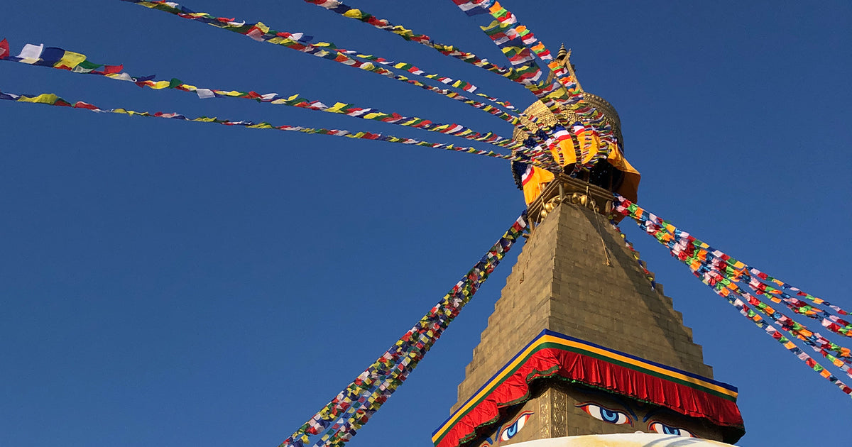 Prayer flags flying high above the eyes of the stupa at Swayambhunath, or "The Monkey Temple" in Kathmandu Nepal