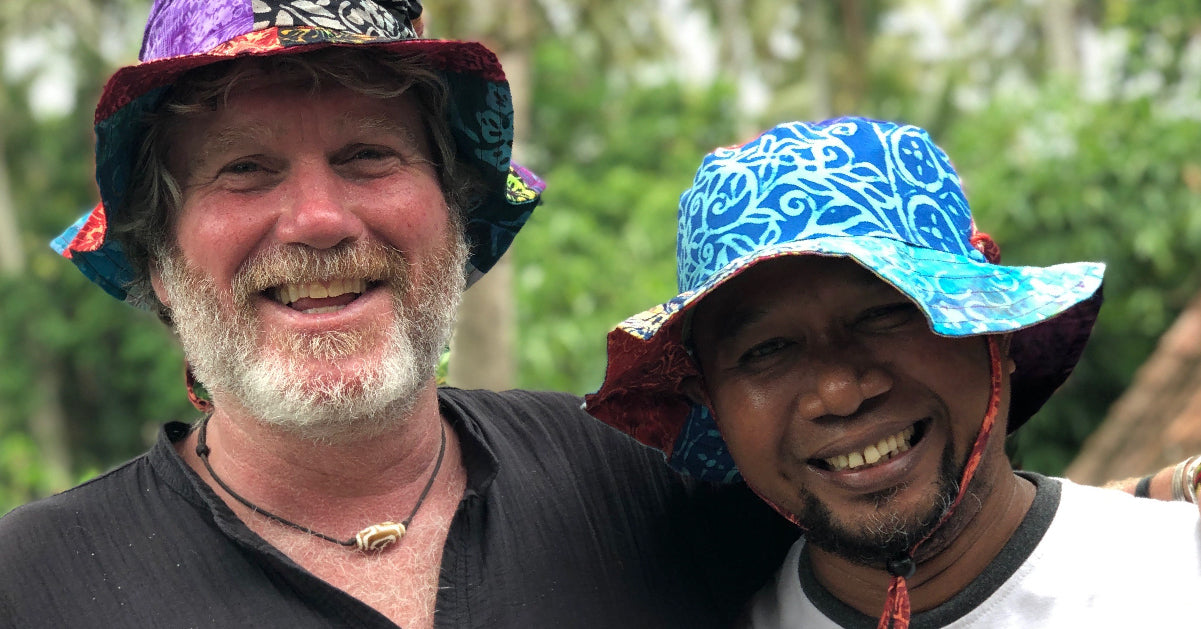 Two smiling men in batik hats, Pete with our Indonesian maker and friend Pepen who is a master of all things batik