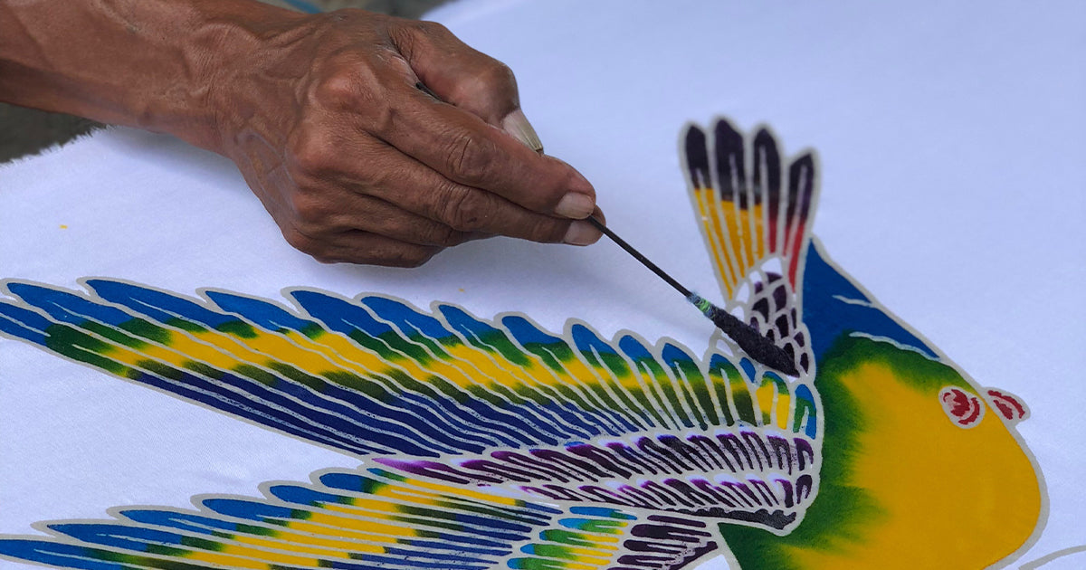 A bird being handpainted using the batik process with a wax comb and natural dyes at the hands of one of the Mexicali makers in Indonesia