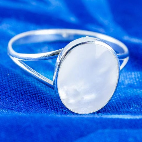 mother of pearl ring in sterling silver on a blue background