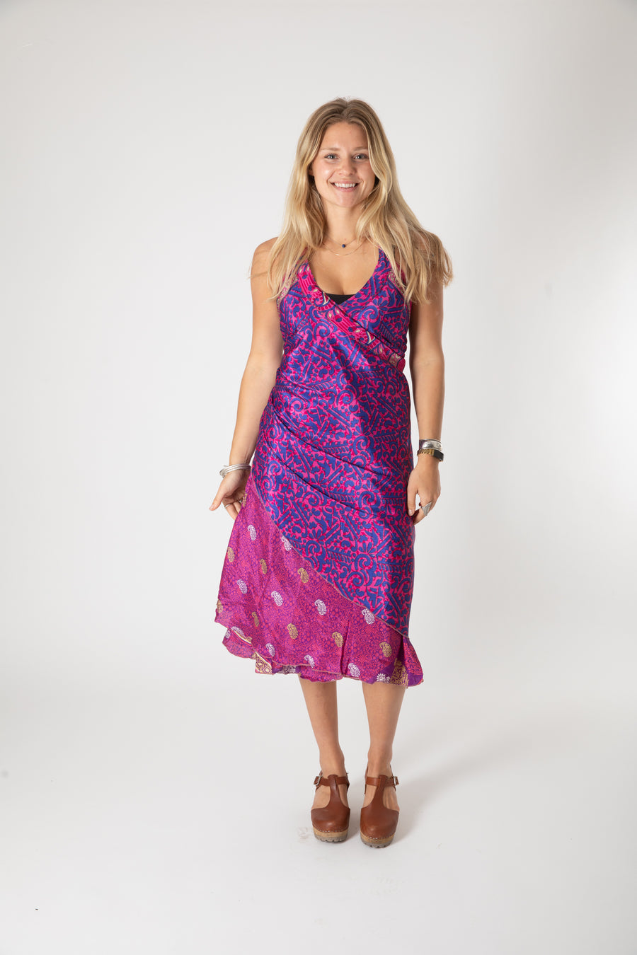 Beautiful blonde hippie girl wearing a recycled silk magic skirt as a boho hippie style silk wrap dress