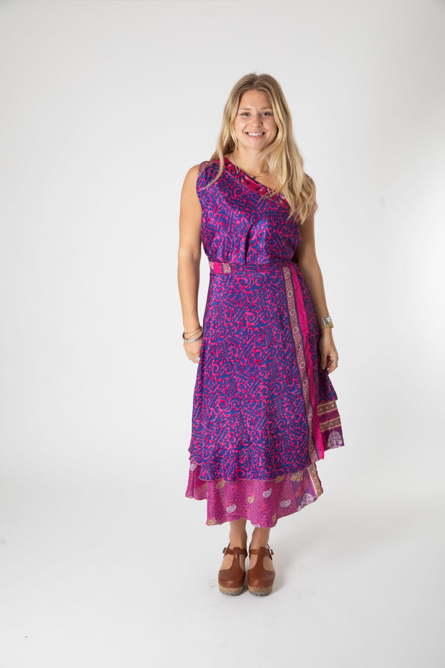 Beautiful blonde hippie girl wearing a recycled silk magic skirt as a boho hippie style silk wrap dress