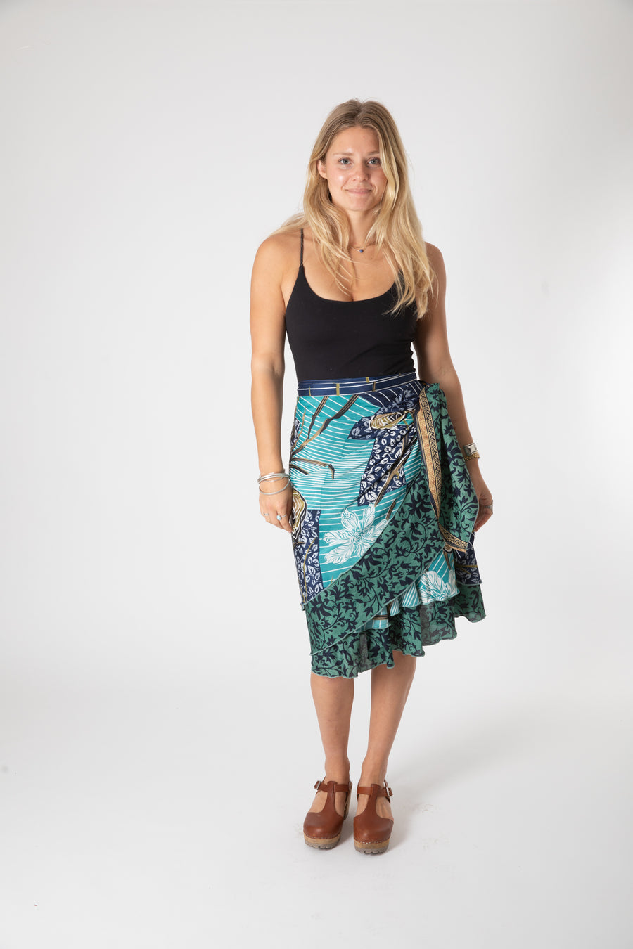 Beautiful blonde hippie girl wearing a recycled silk magic skirt as a boho hippie style silk wrap skirt