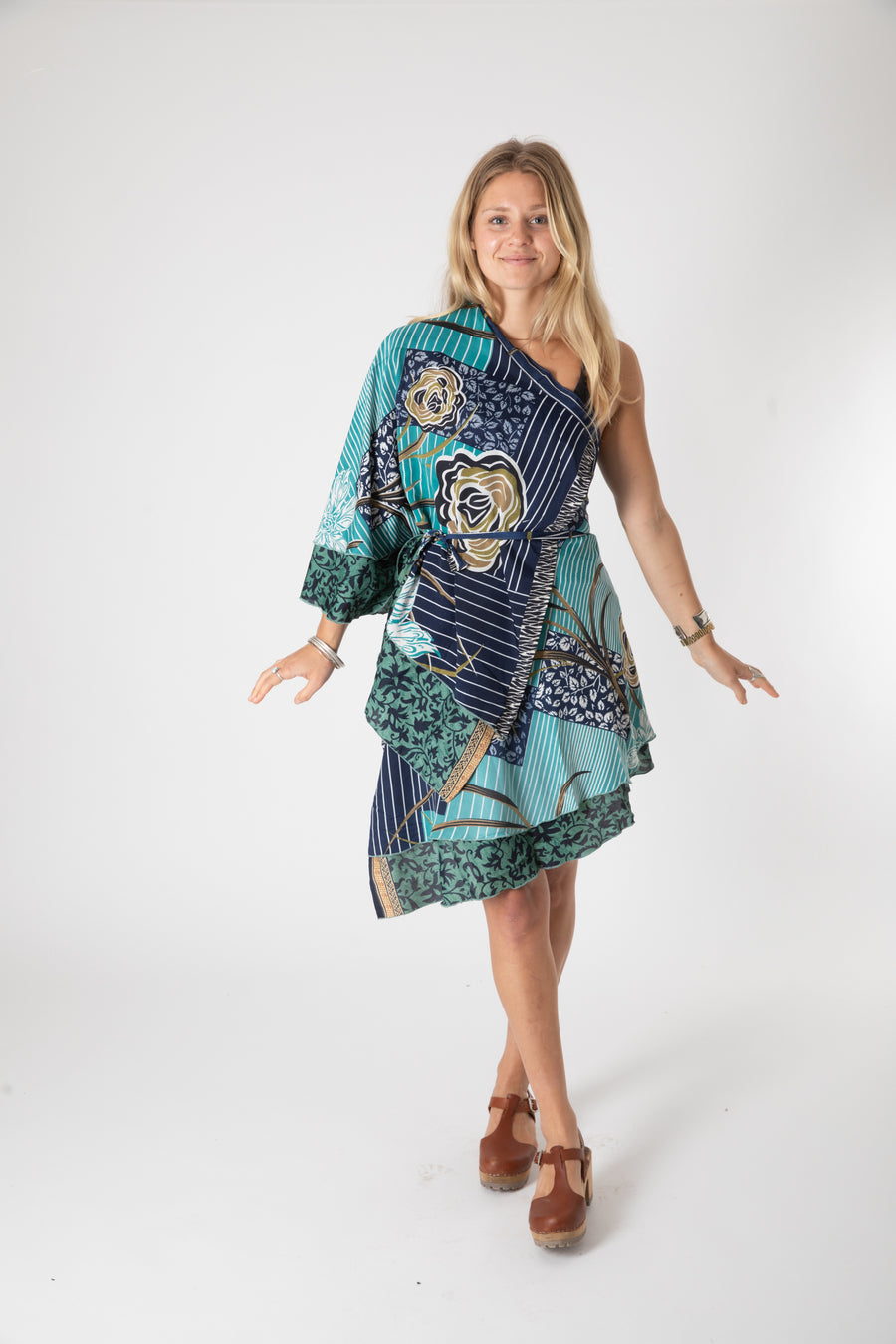 Beautiful blonde hippie girl wearing a recycled silk magic skirt as a boho hippie style silk kimono top