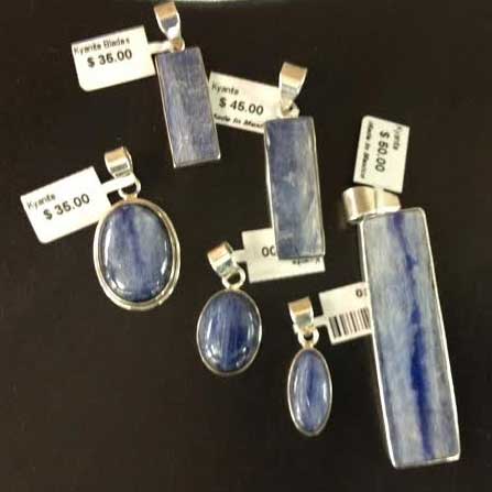 an assortment of kyanite jewelry set in sterling silver with price tags attached