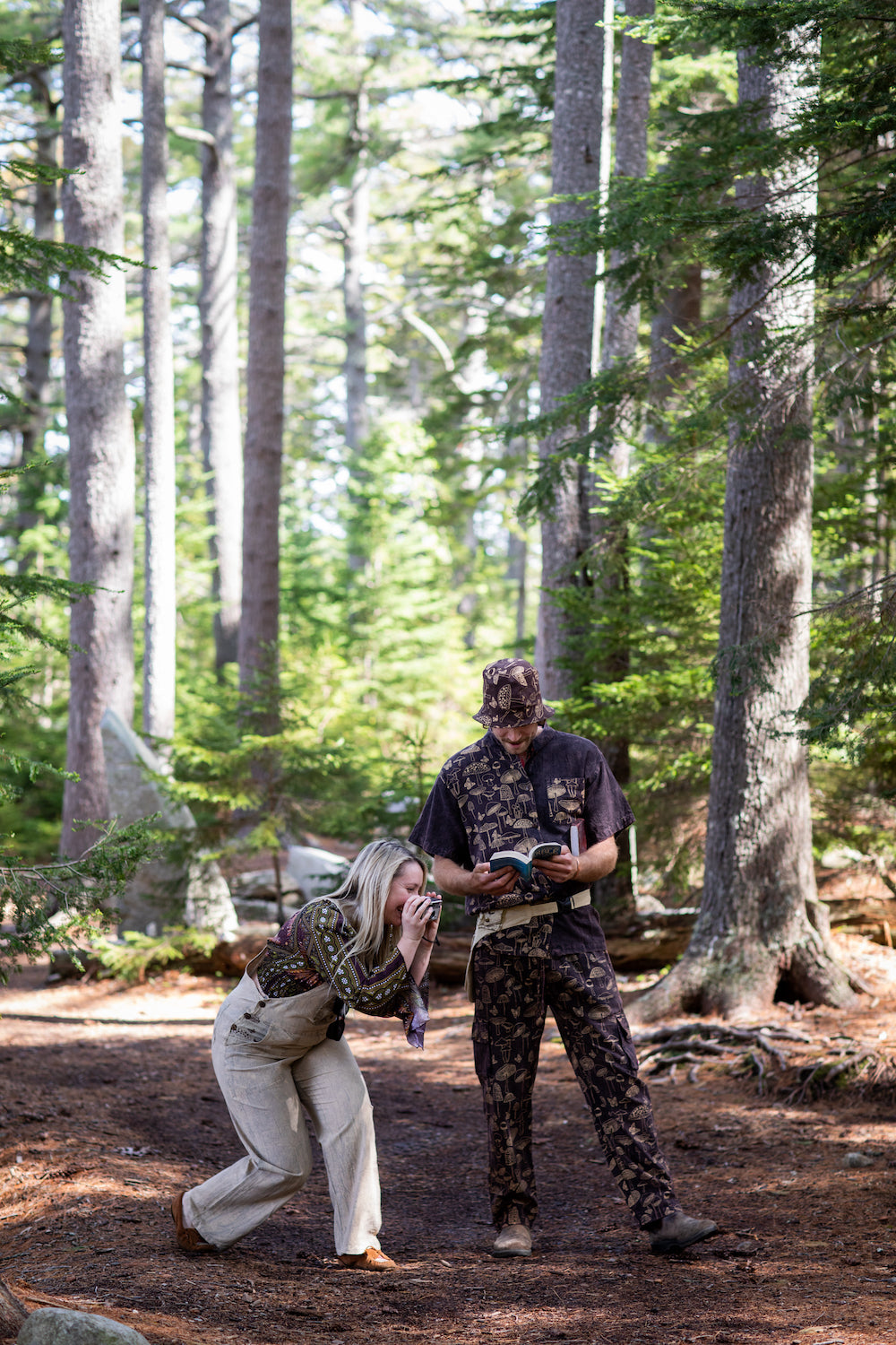 Two friends, a man and a woman adventuring through the forest in matching mushroom outfits
