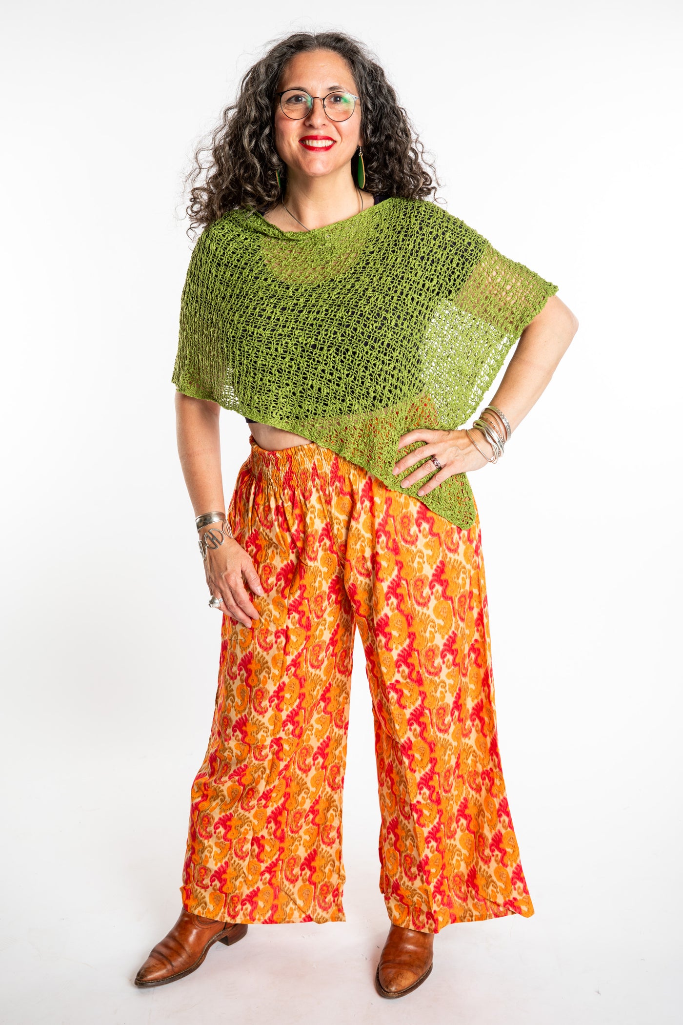 Susan wearing the size M/L Printed Penny Lane pants in Flashback with the loose knit poncho
