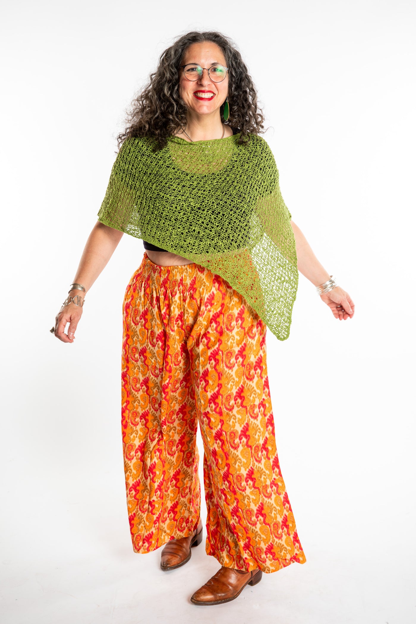 Susan wearing the Olive loose knit poncho with Printed Penny Lane Pants