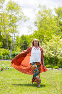 Woman wearing white tank top, walking in a field
