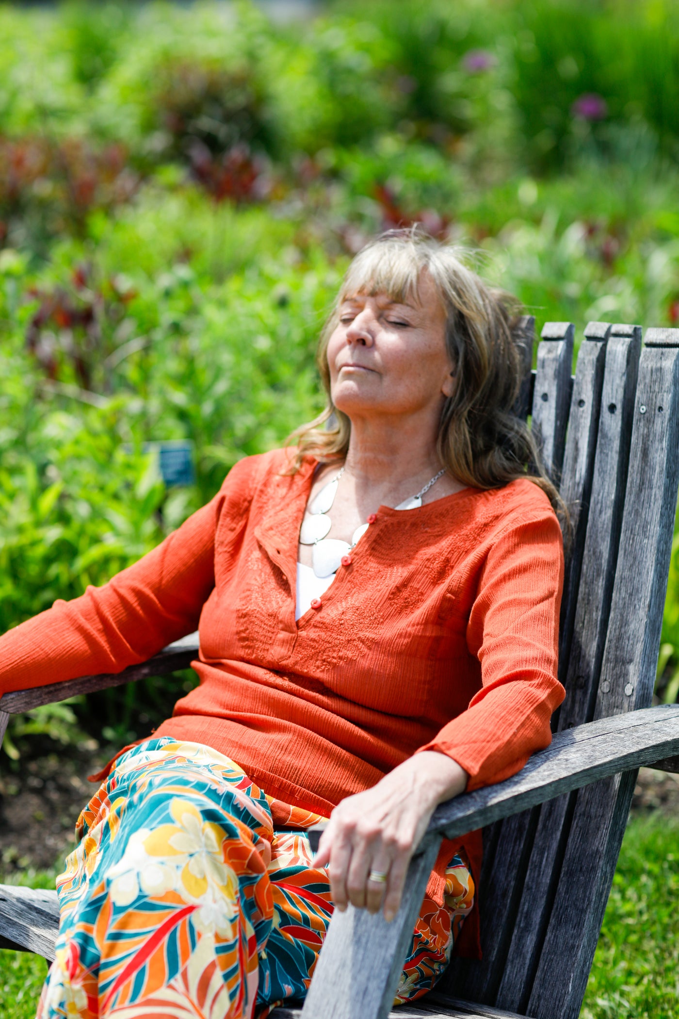 Woman wearing cotton, kurta top, relaxing in chair outside