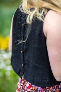 Holly wearing S/M black sleeveless cotton top with textured fabric and relaxed fit
