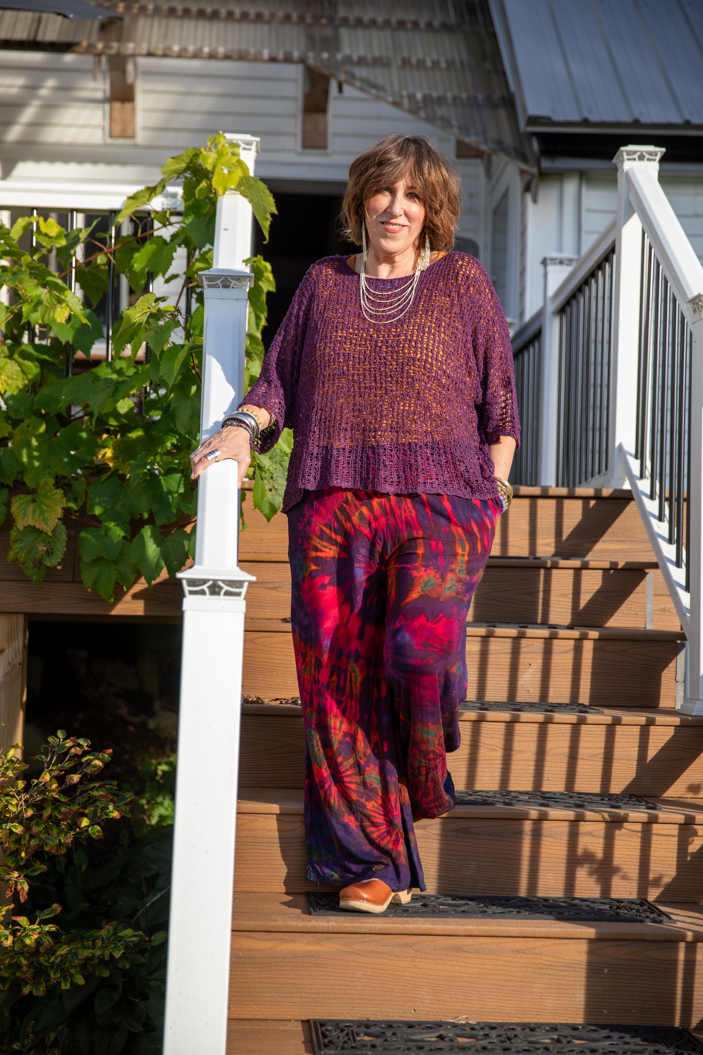 Betty wearing the purple butterfly loose weave top with tie dye pants