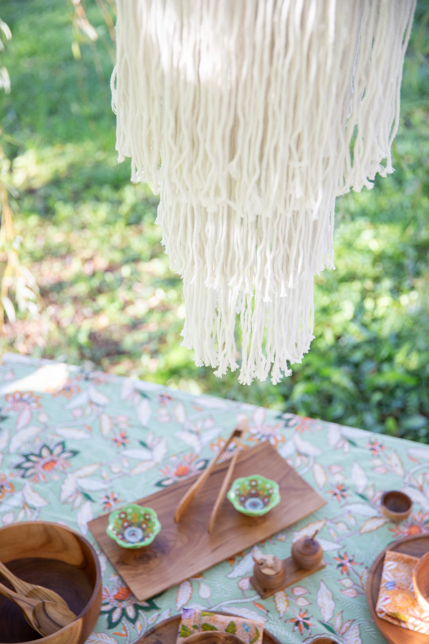 macrame chandelier hanging over bohemian table 