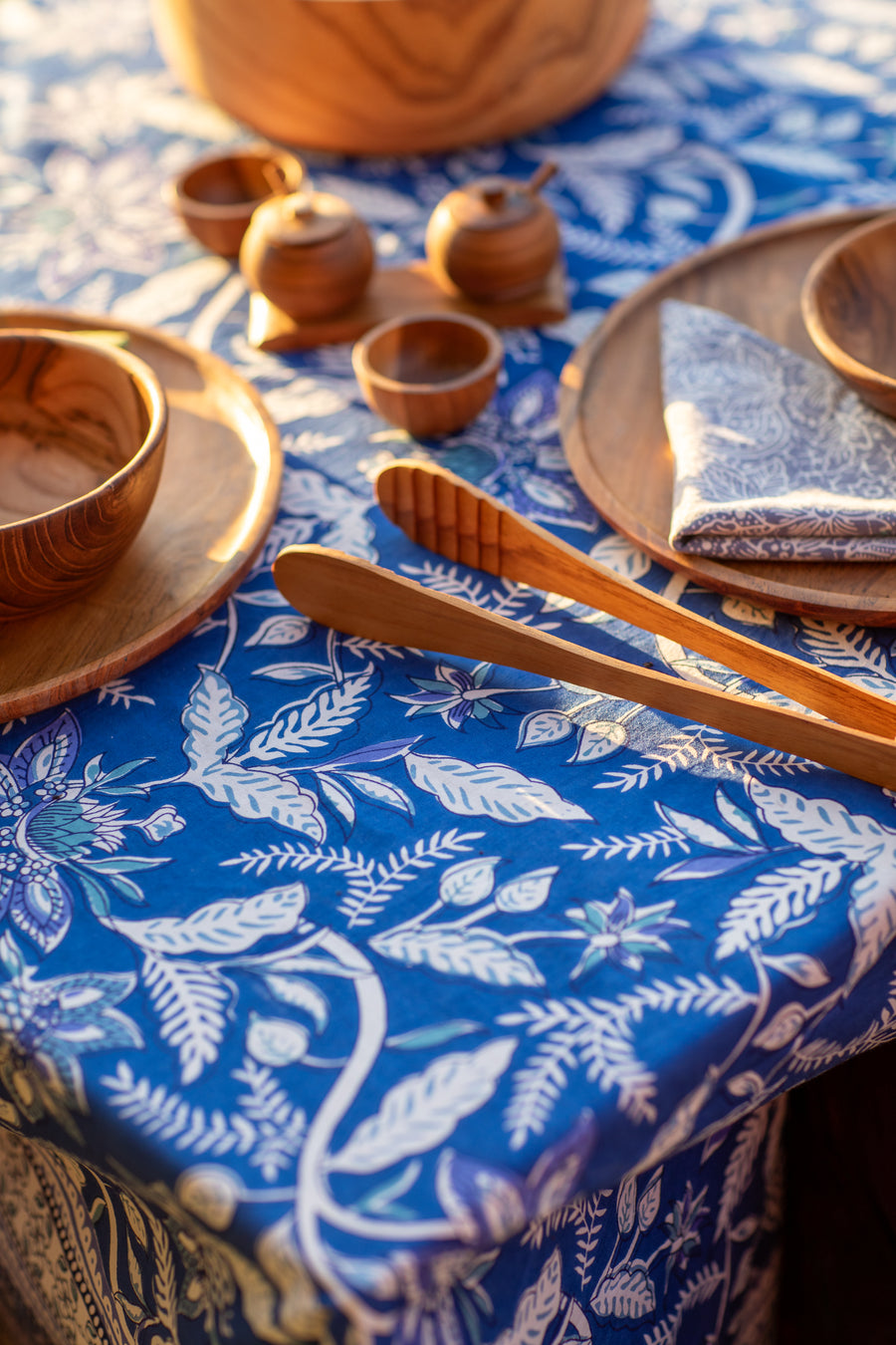 teak wood table decor on a block print tablecloth
