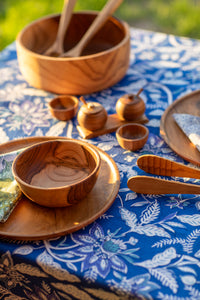 teak wood dining decor on a block print tablecloth