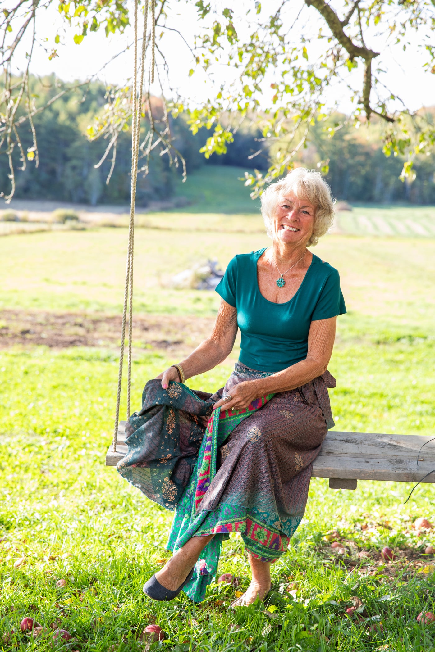 Penny wearing the L Kyra Cross Back Crop Top and long sari silk wrap skirt