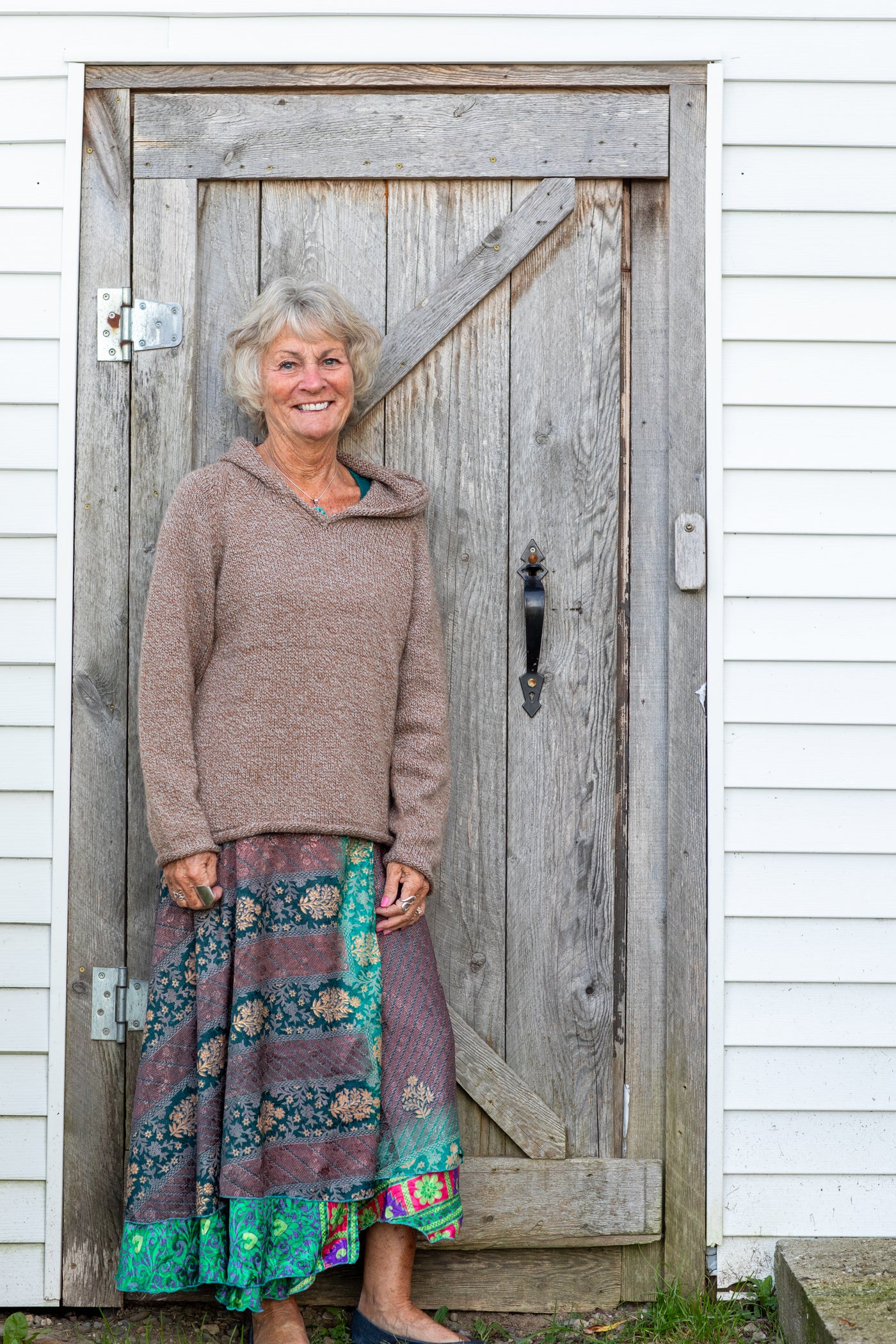 Penny wearing the S hooded alpaca sweater in Tan 