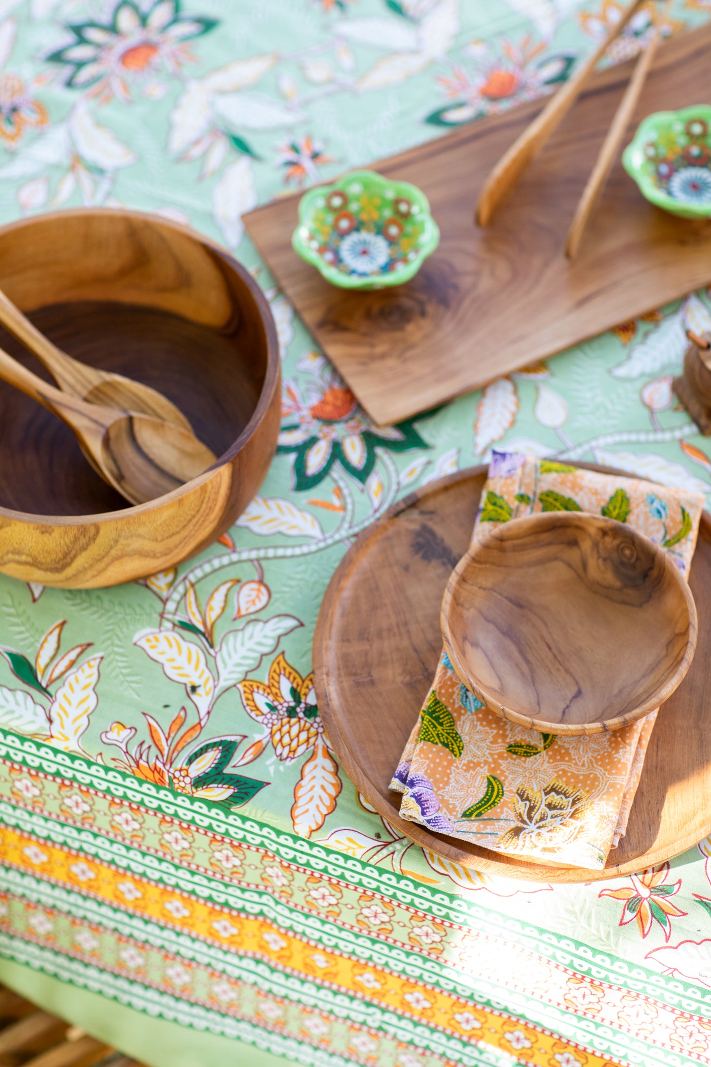 teak table decor on a block print tapestry