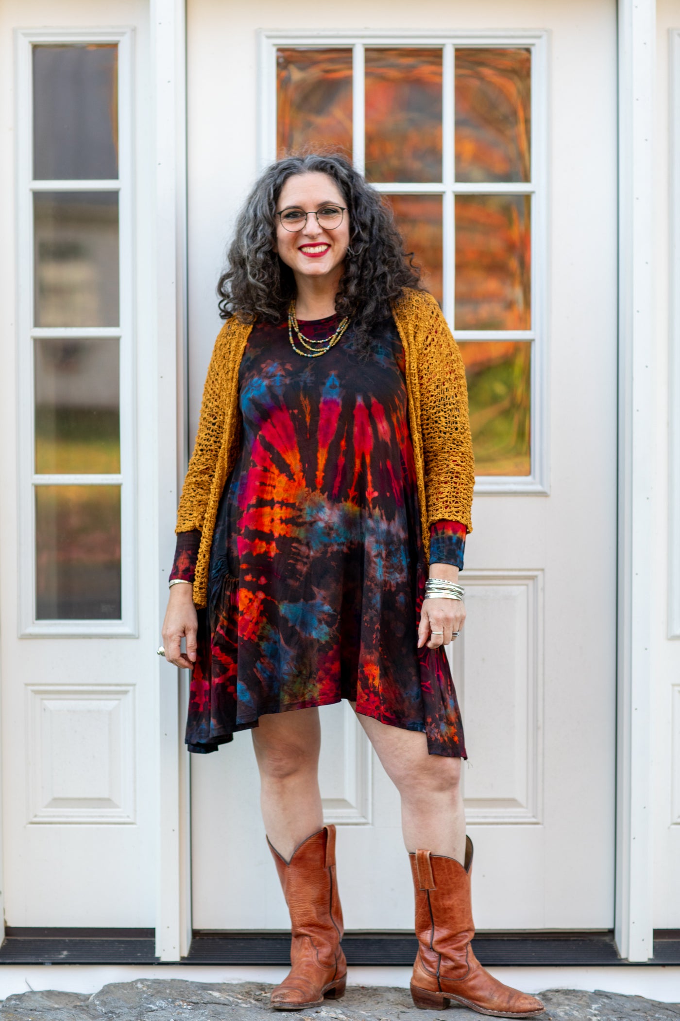 Susan wearing the brown althea tie dye dress and talia loose weave cardigan