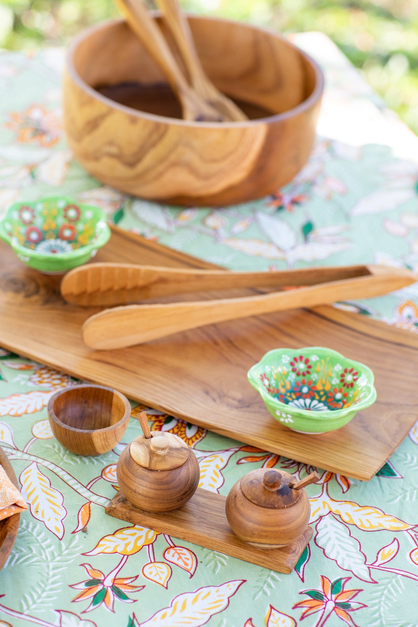 teak wood table decor on a block print tapestry