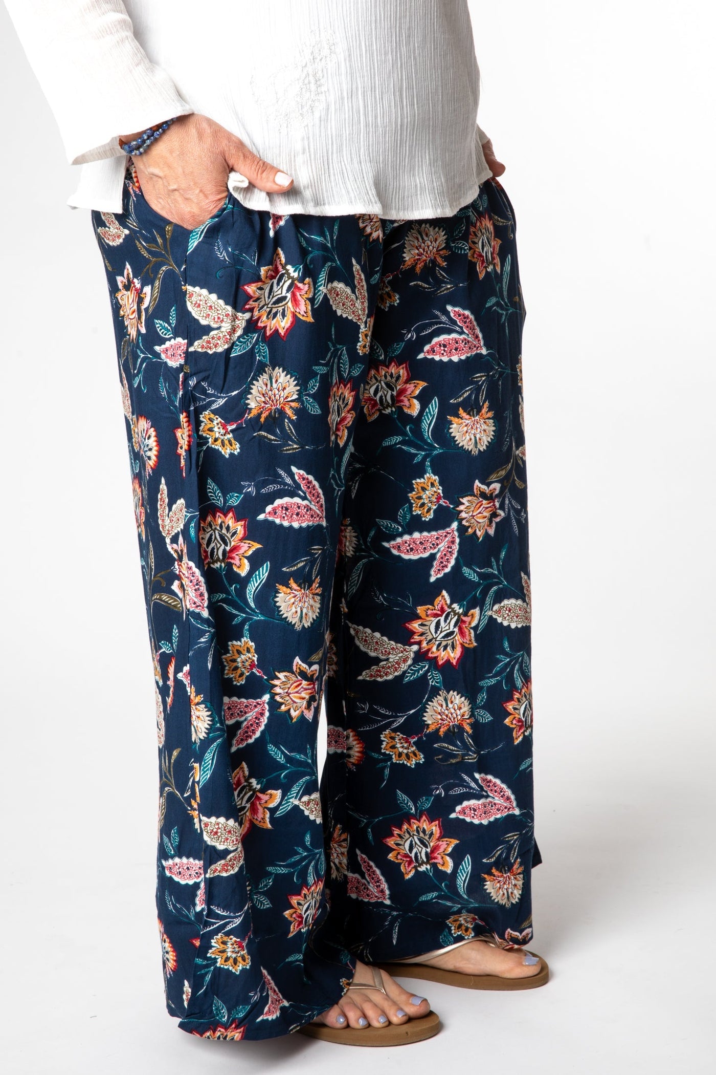 Betty is wearing the M/L Floral Blue Blooms Printed Penny Lane Pants