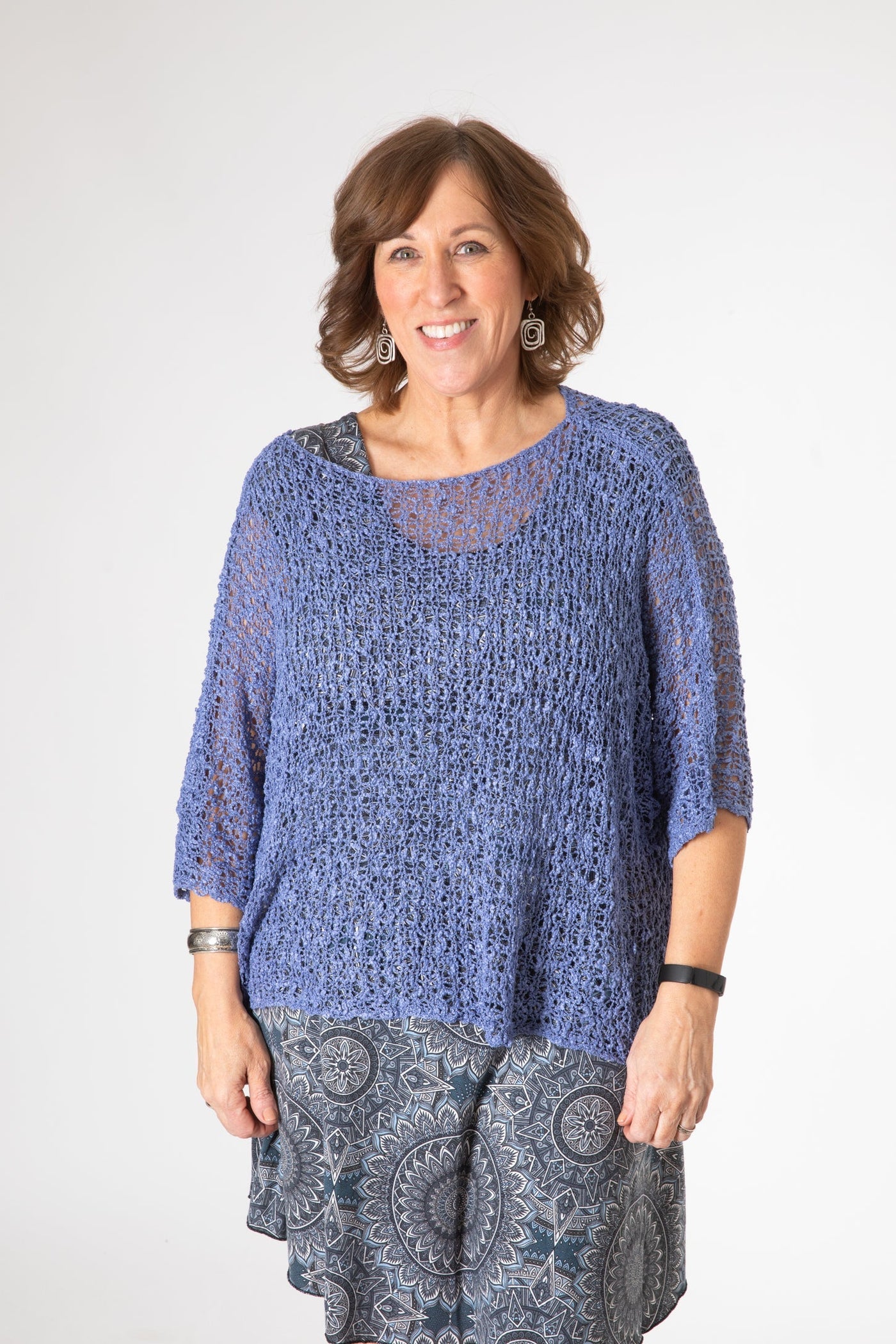 Betty is wearing the Butterfly Lightweight Poncho in Blue