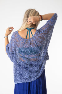 Sophie is wearing the Butterfly Lightweight Poncho in Blue