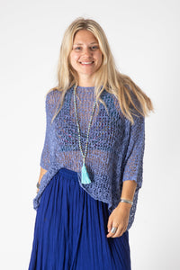 Sophie is wearing the Butterfly Lightweight Poncho in Indigo