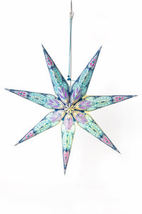 A turquoise paper star lantern with 7 points in front of a white backdrop. 
