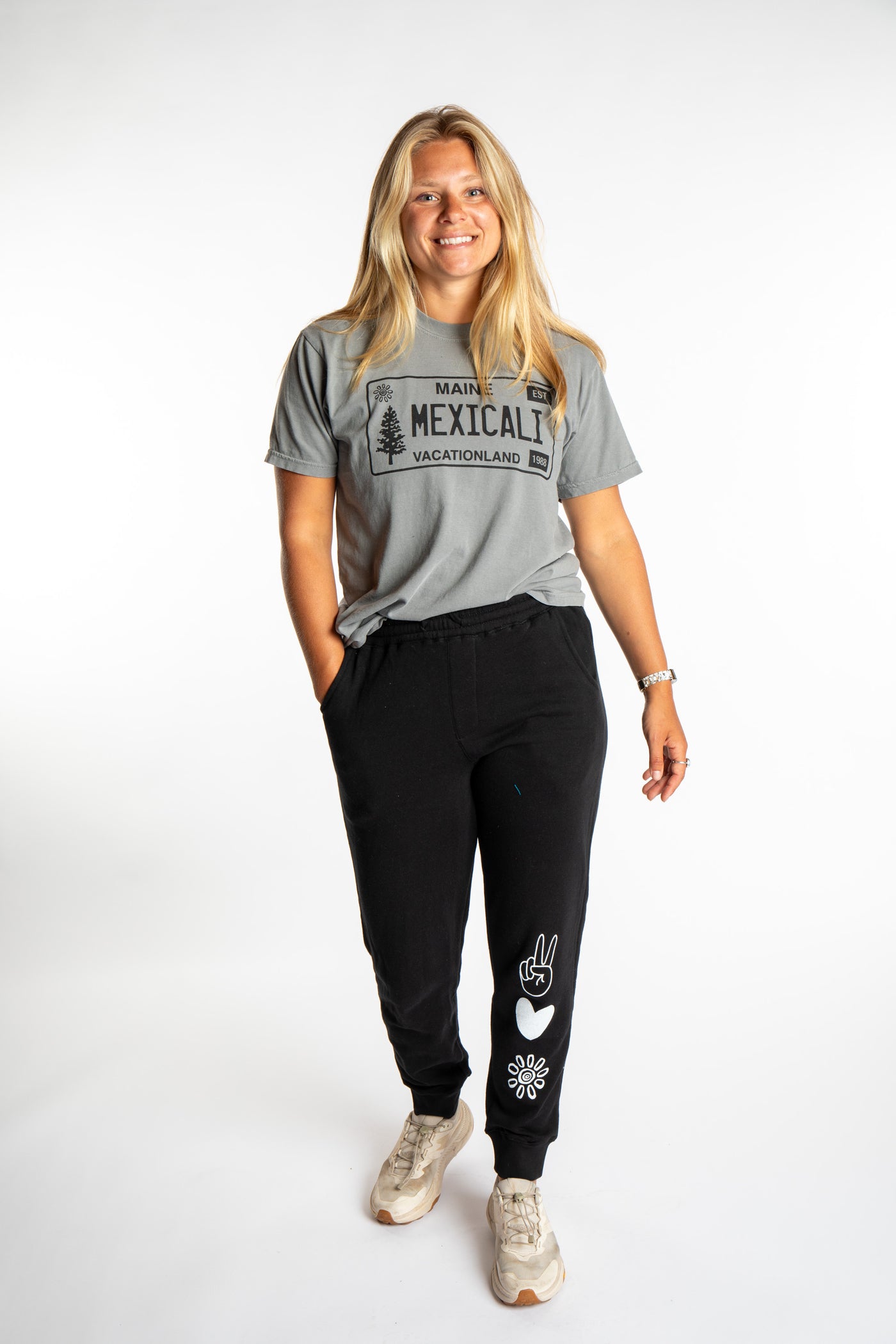 Sophie wearing the size S Heather Gray License plate tee with black branded joggers