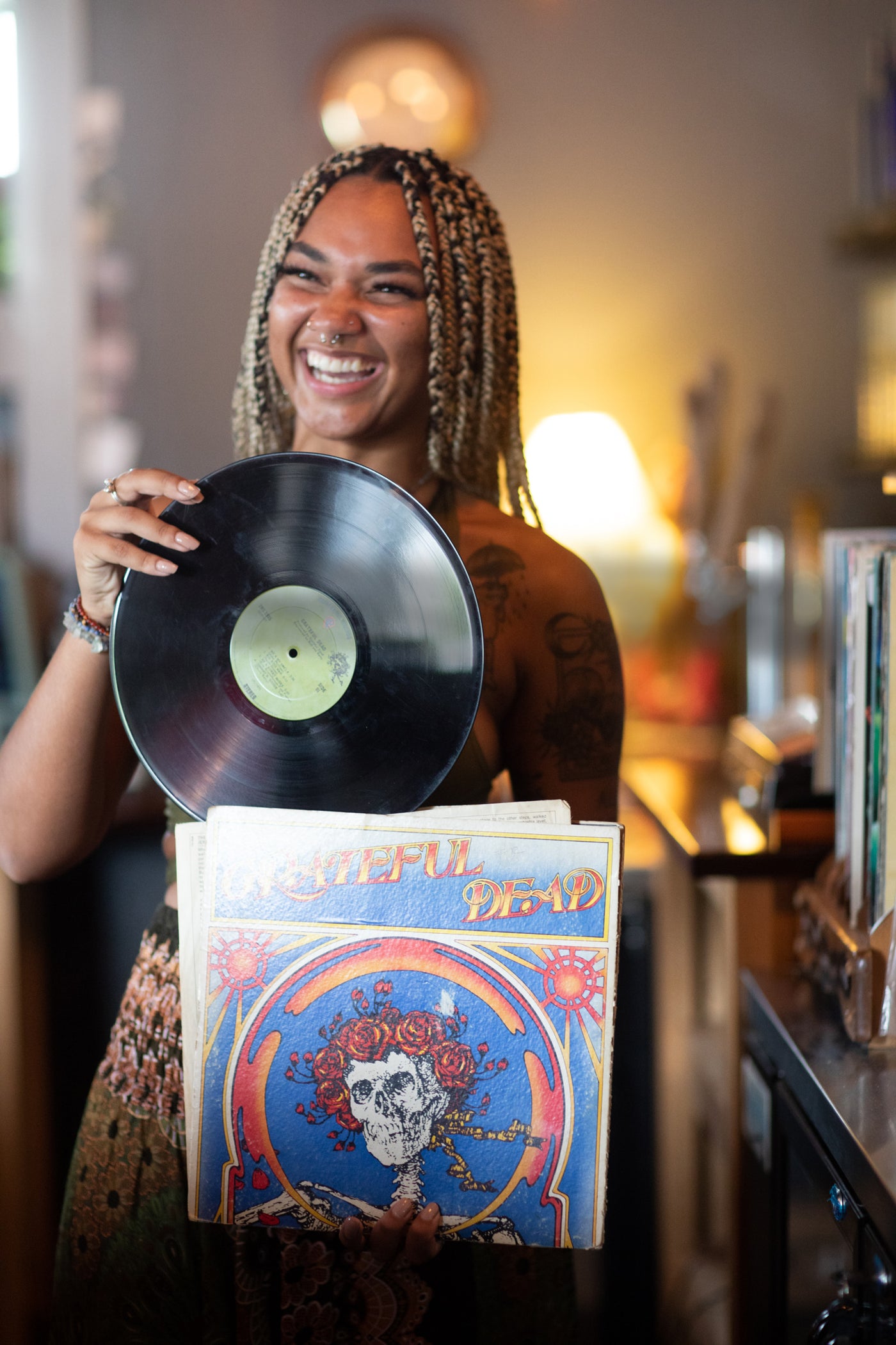 Beautiful hippie girl with vinyl record of Grateful dead, indie style