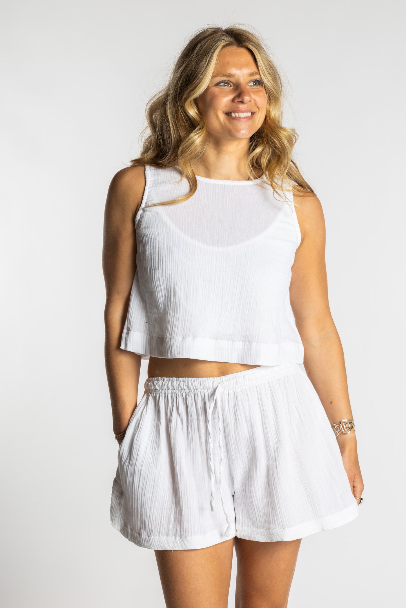Sophie wearing a white ivory cotton summer matching set with sleeveless crop top and drawstring shorts, size S/M