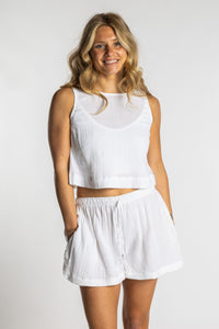 Sophie wearing a white ivory cotton summer matching set with sleeveless crop top and drawstring shorts, size S/M