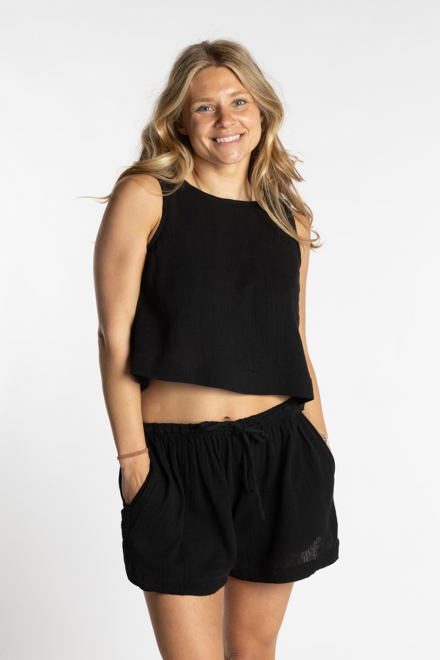 Sophie wearing a black cotton summer matching set with sleeveless crop top and drawstring shorts, size S/M