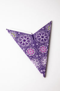 Cyclone Purple embroidered paper star folded up, out of the package