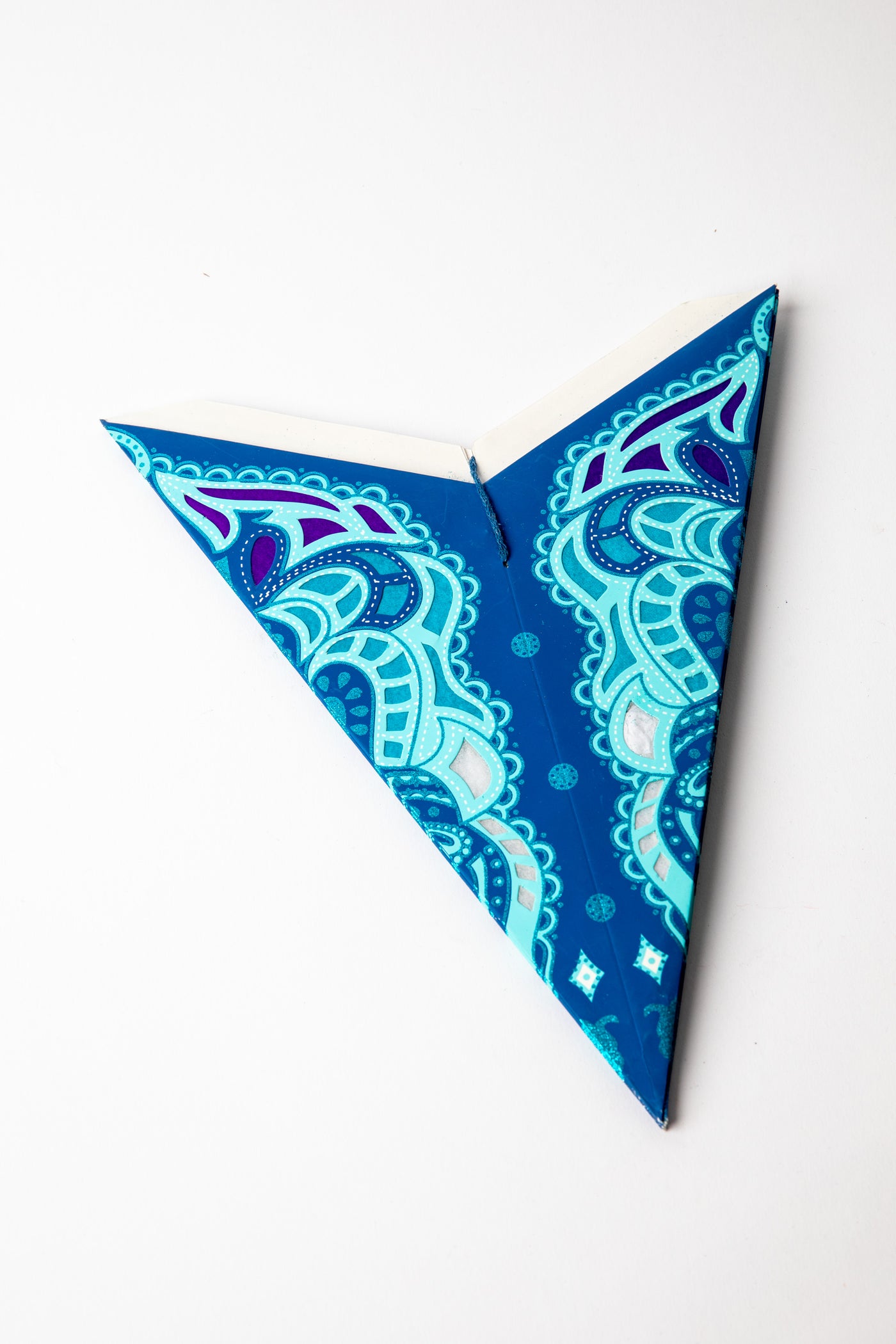 Ganesh Midnight embroidered paper star folded up, out of the package