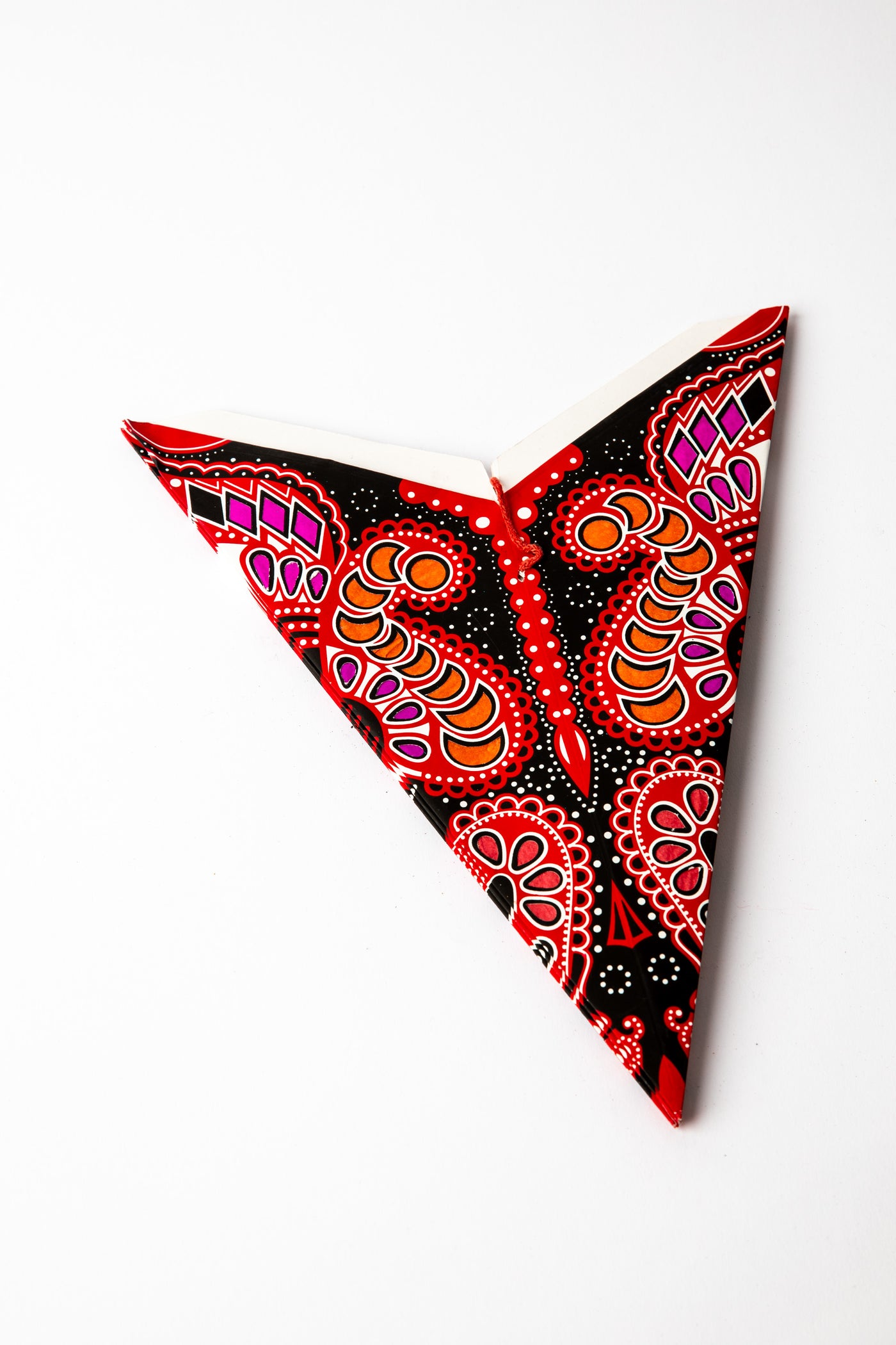 Ganesh Red Black embroidered paper star folded up, out of the package