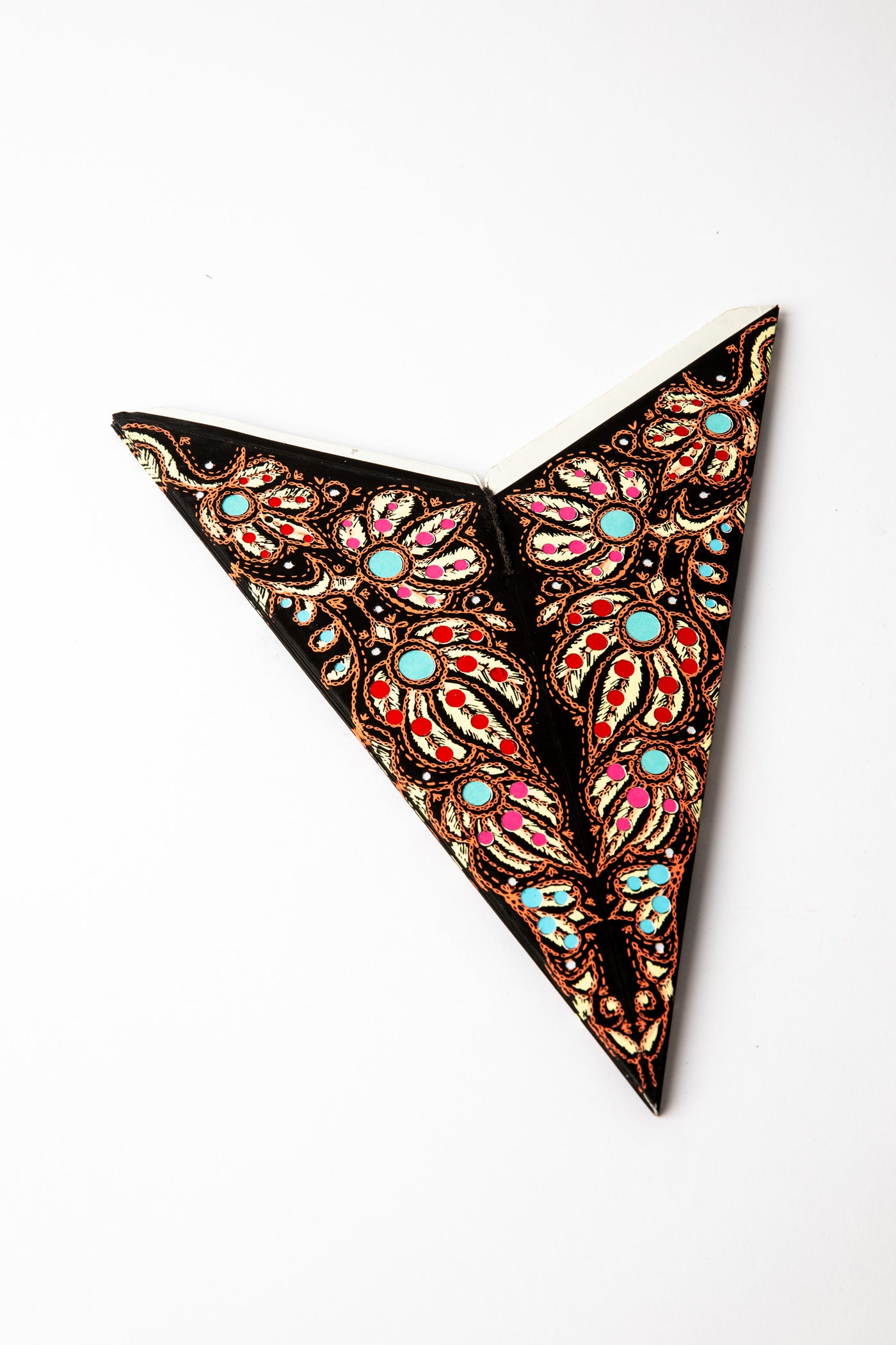 Mari Black embroidered paper star folded up, out of the package
