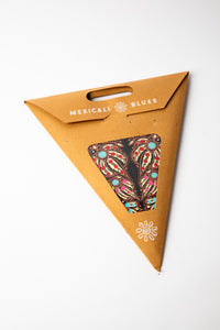 Mari Black embroidered paper star, folded up, in packaging